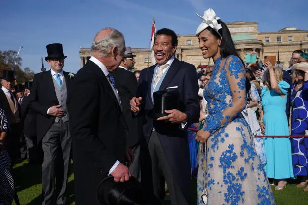 Last year the King greeted Lionel Richie and Lisa Parigi during a lavish Garden Party