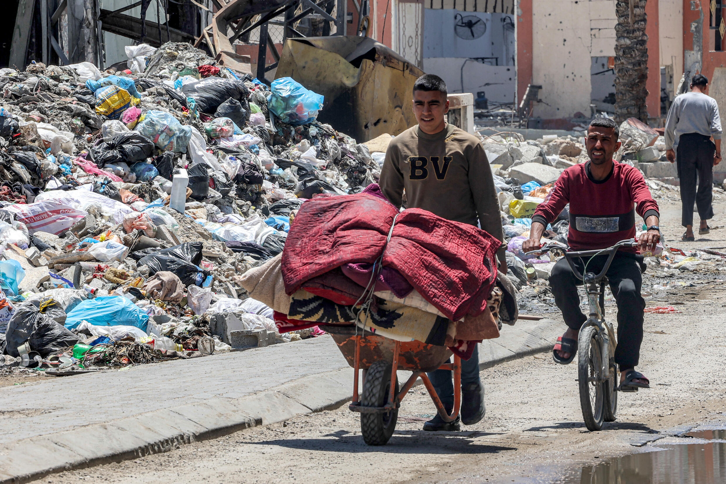 Ein Mann benutzt eine Schubkarre, um Habseligkeiten im Stadtteil Zeitun in Gaza-Stadt zu transportieren